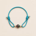 Blue Lagoon natural multicolor tourmaline bracelet with turquoise blue cord and gold-tone details by Sense Jewelry