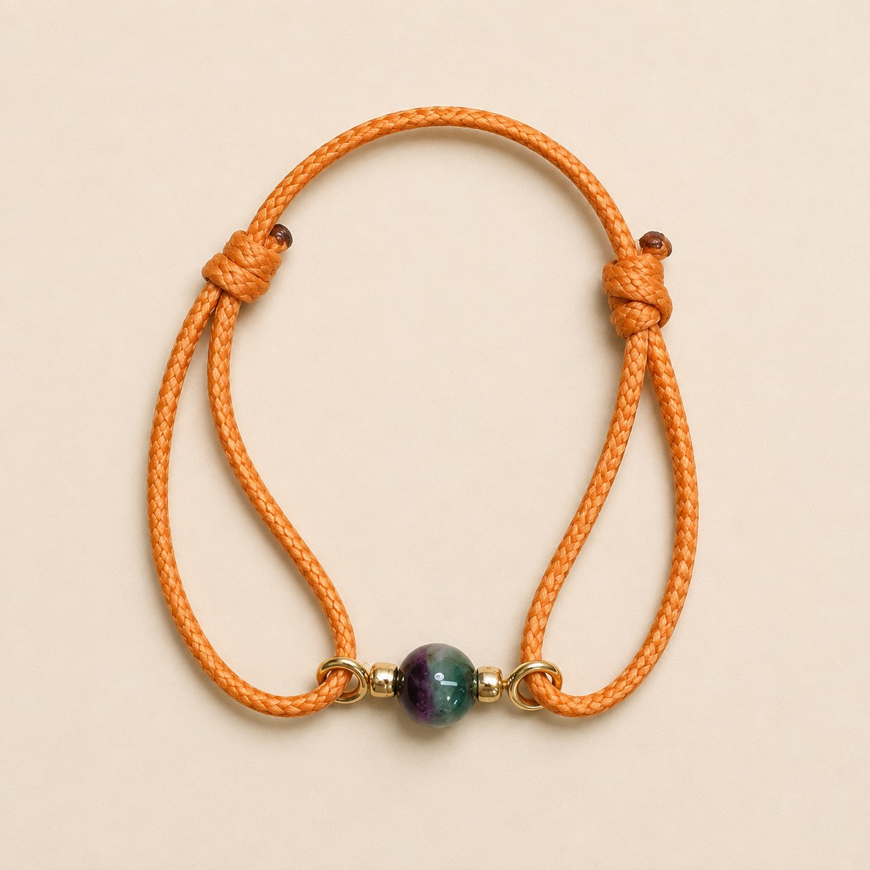 Petit Soleil orange cord bracelet with 7mm bi-color Watermelon Tourmaline and gold-plated details.