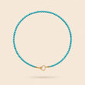 Little Crush natural turquoise bead necklace with a sparkling gold-tone heart clasp on an ivory background.