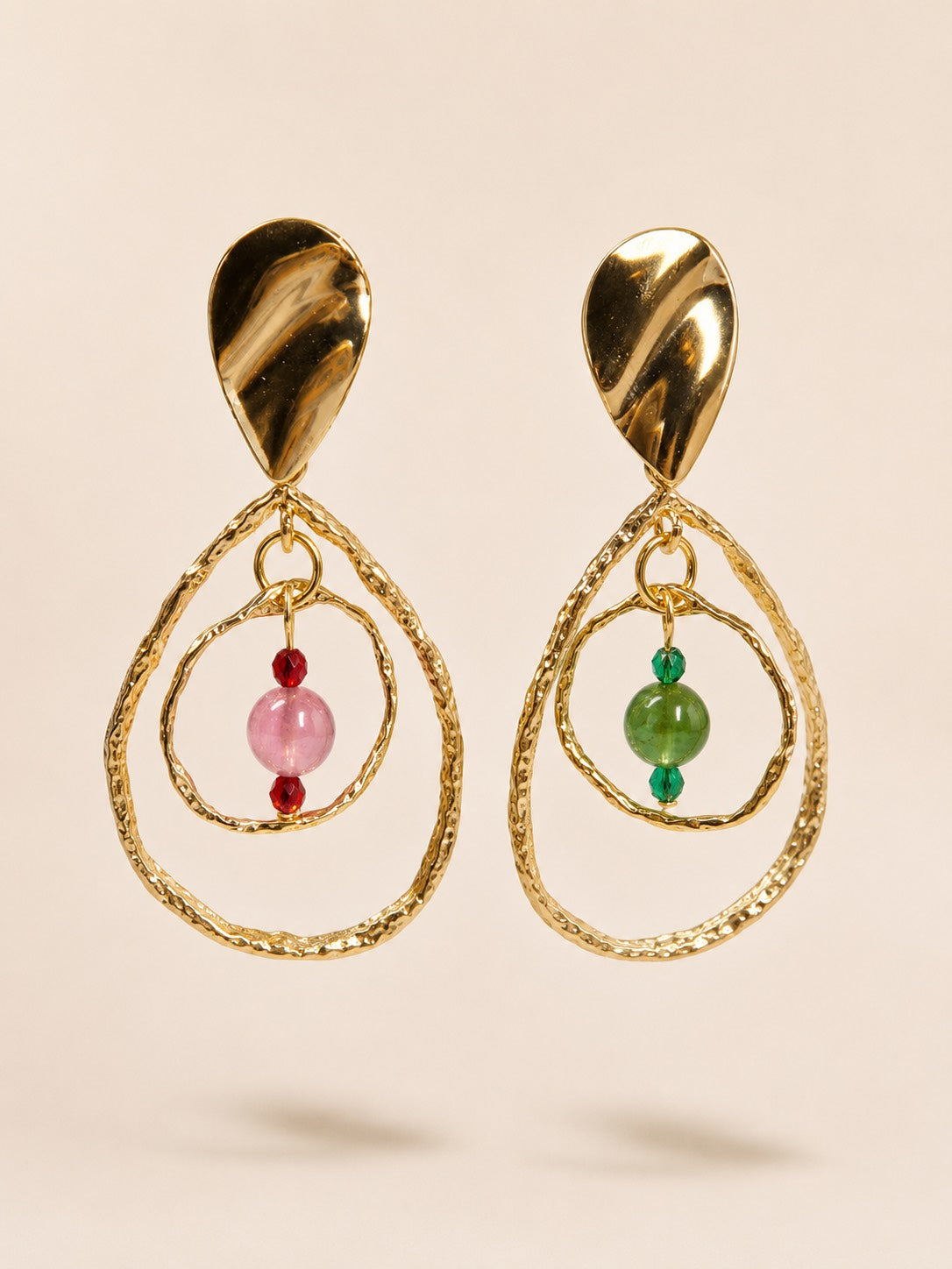 Orbit in Bloom asymmetric gemstone drop earrings with hammered gold-tone organic hoops and pink and green gemstone beads.