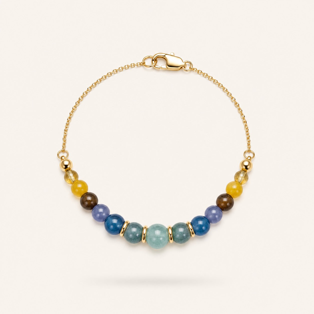 Soleil et Mer bracelet by Sense Jewelry featuring natural Aquamarine, Blue Tourmaline and Yellow Jade gemstones on an 18K gold-plated sterling silver chain.